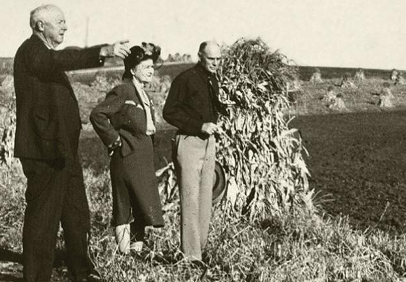 photo of three people standing in dust bowl ridden farm