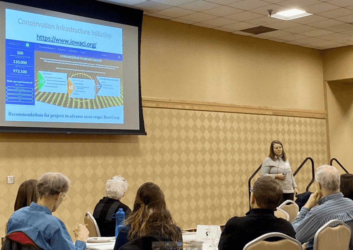 Sara Carlson speaking at cover crop boot camp. Sara Carlson speaks to a conference room of over one hundred farmers about cover crop farming.