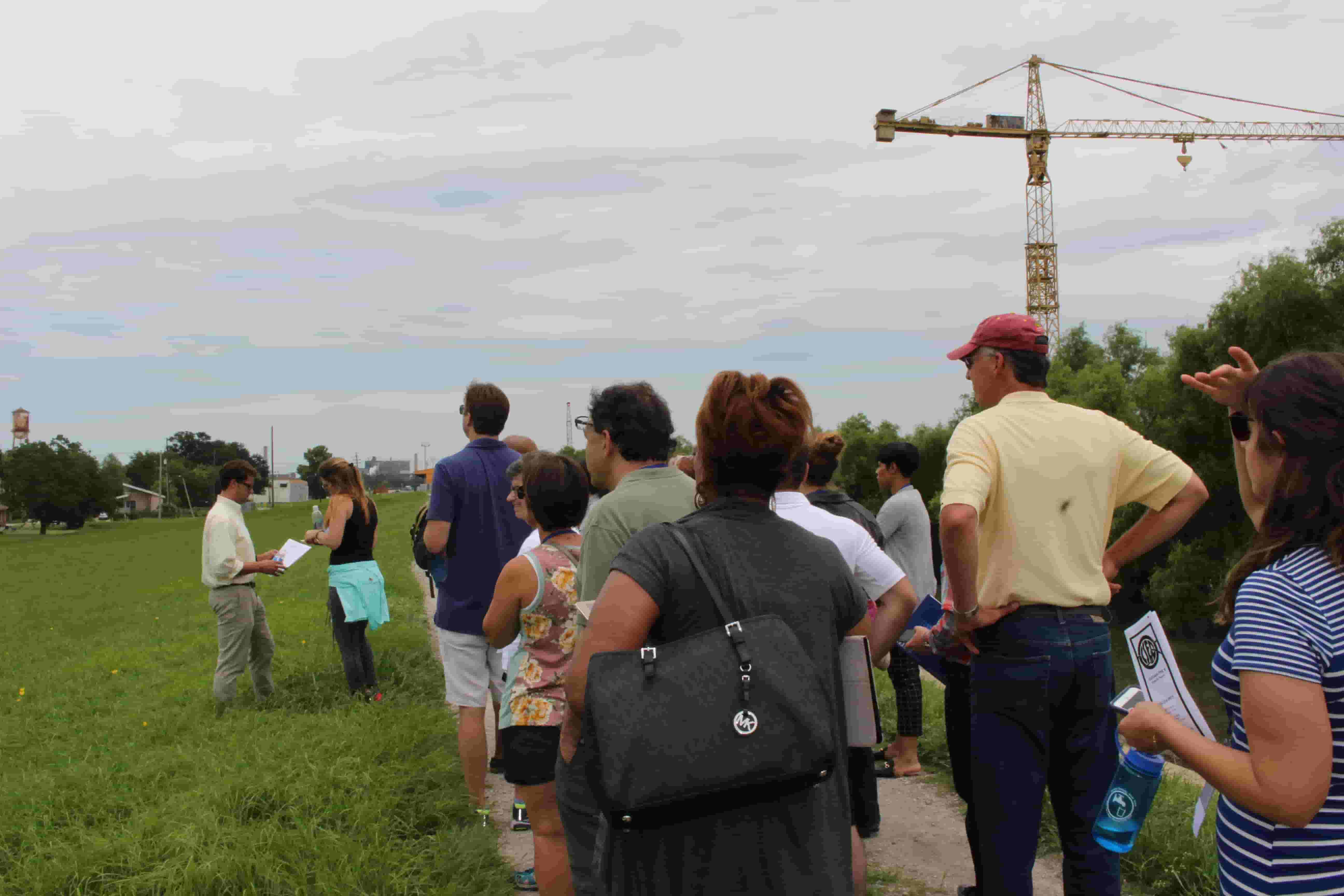 Delegates listen to speaker at excursion site, part of the One Water Summit agenda
